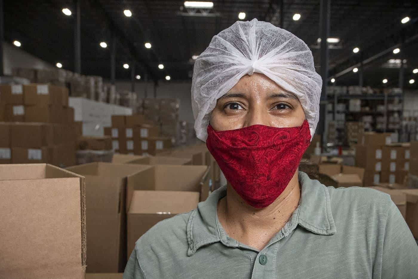 Workers packing boxes on a production line in a packaging facility