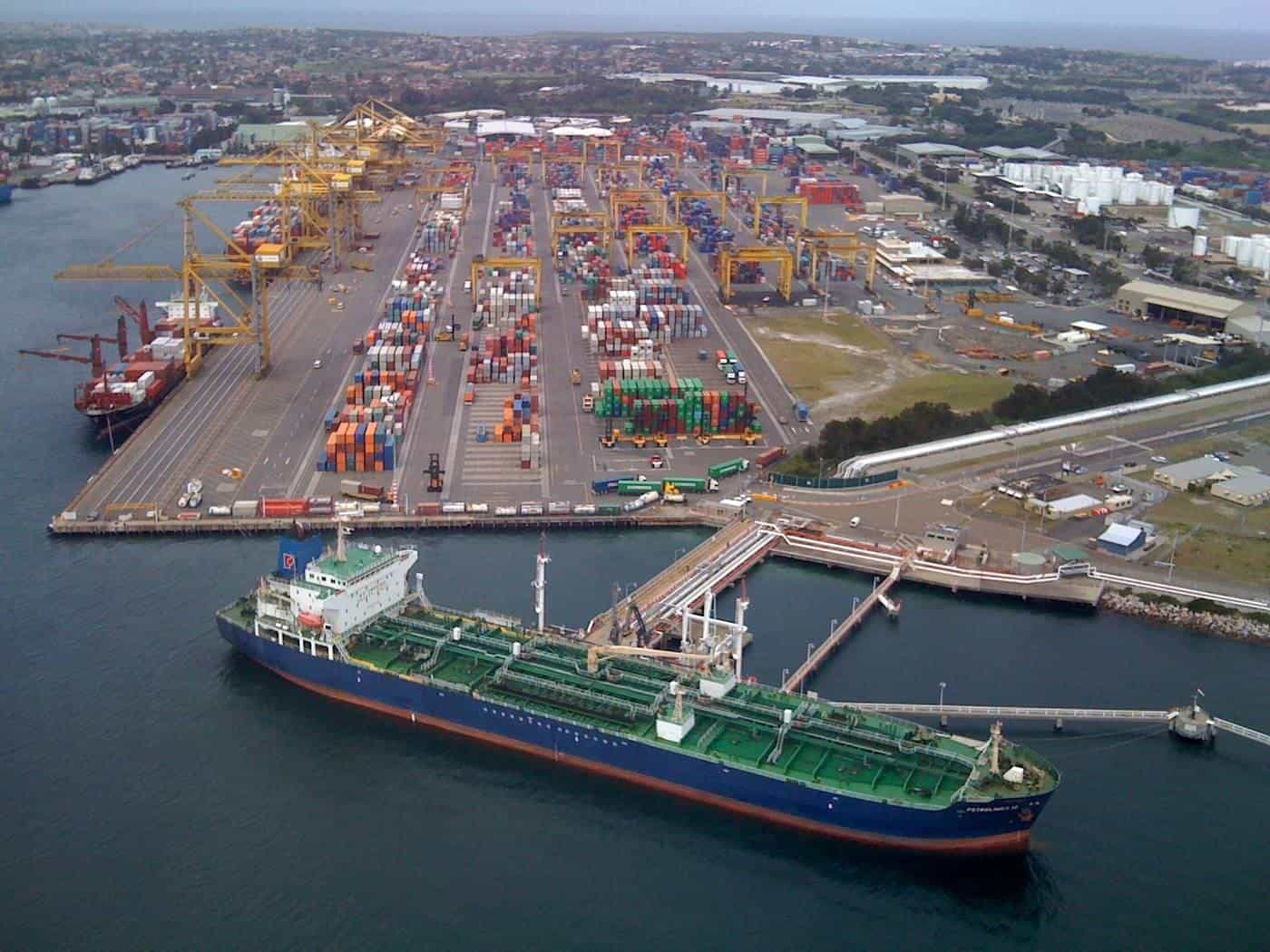 An aerial view of a busy container port in Sydney with stacks of shipping containers