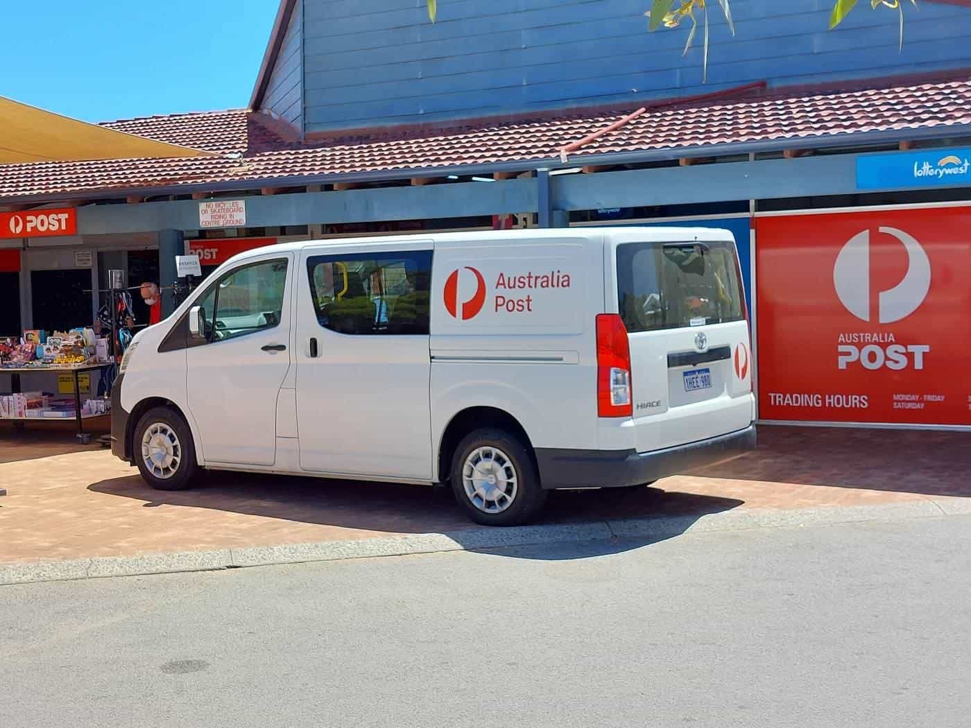 A white Australia Post delivery van parked outside a suburban post office in Western Australia